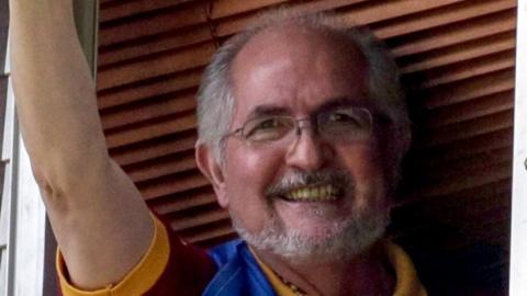 Metropolitan mayor Antonio Ledezma waves from the window of his resident in Caracas, Venezuela, 16 July 2017