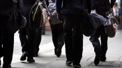 Schoolchildren walking with backpacks