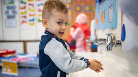 boy washing hands at school