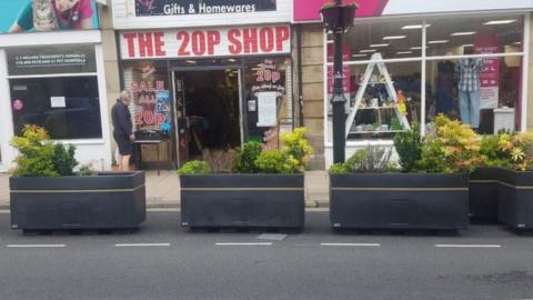 Planters in front of a shop