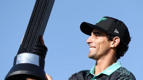 Joaquin Niemann lifts the trophy after winning the LIV Golf event in Jeddah
