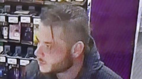 CCTV image of Alex Ogden, who is wearing a dark North face jacket and slicked back hair