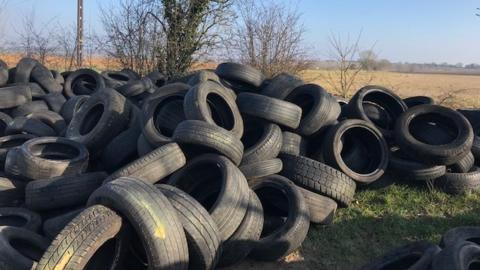 Huge pile of tyres dumped on land