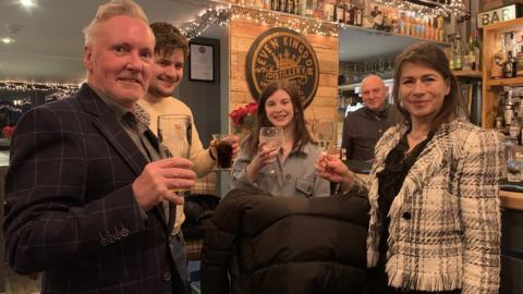 Mark Ellison (second from right) and customers celebrate the end of the Manx lockdown