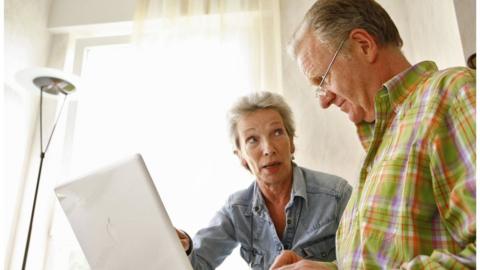 An older couple with a computer