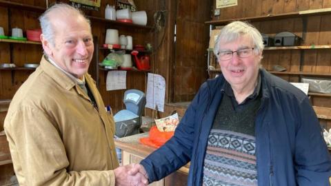 Ernest Clothier with Ray Carver, one of his last customers