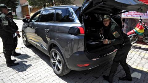 Police officers check a vehicle outside La Rinconada gated community, where the Mexican embassy is located, in La Paz on December 30, 2019.