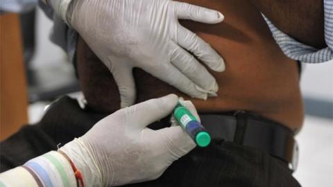 A medical assistant administers an insulin shot to a diabetes patient at a private clinic in New Delhi on November 8, 2011.