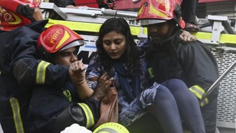 Woman is rescued by firefighters