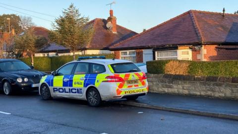 A police car outside a house