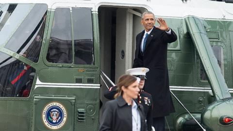 Barack Obama waves as he boards a Marine helicopter at the US Capitol.