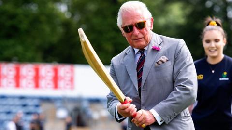 Thwack! Charles shows off his sporting skills in Wales visit