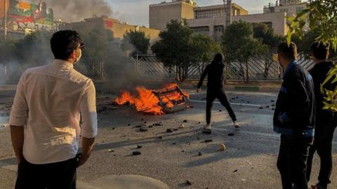 Iranian protesters block a road during a demonstration against an increase in gasoline prices in the central city of Shiraz on