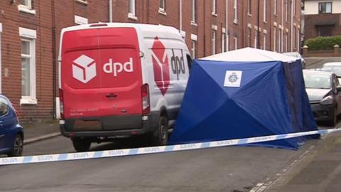 Police forensics tent next to a DPD van