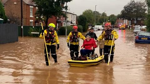 Woman in wheelchair rescued from flood water