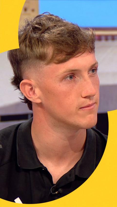 England amputee footballer Thomas Atkinson speaking to BBC Breakfast. He is wearing a black England amputee football shirt.