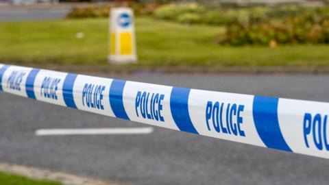 Police Tape at Roadside - stock photo