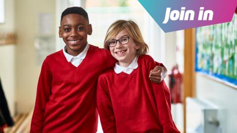 Two boys stand in a school corridor. One has their arm around the other's shoulders. They are wearing white polo shirts and red jumpers. "Join in" is superimposed in the top right corner of the image.