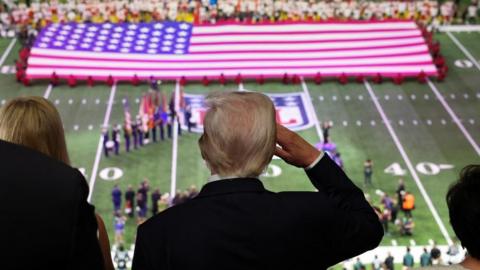 U.S. President Donald Trump salutes during the national anthem at the Super Bowl in New Orleans, Louisiana, U.S., February 9, 2025