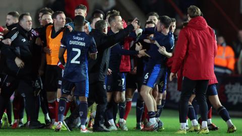 A group of Lincoln City and Exeter City players clash after the Imps' win at St James Park on Tuesday 
