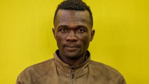 Collins Jumaisi Khalusha, in a brown jacket, looks straight on at the Kiambu law Courts in Kiambu on July 16, 2024.