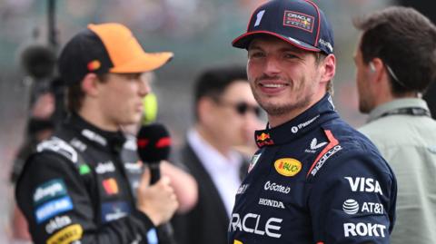 Max Verstappen smiles after taking pole for the British Grand Prix as Oscar Piastri was interviewed in the background