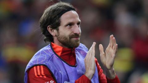 Joe Allen claps Wales fans earlier this season