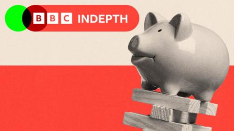 A piggy bank balanced on top of some falling wooden blocks