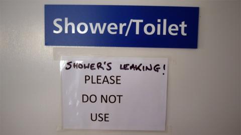 Sign at North Tees Hospital saying the shower/toilet is leaking