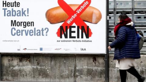 No-campaign posters have sprung up warning: "Today tobacco, tomorrow sausages?"