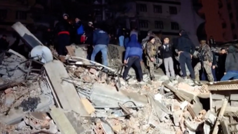 People stood on rubble