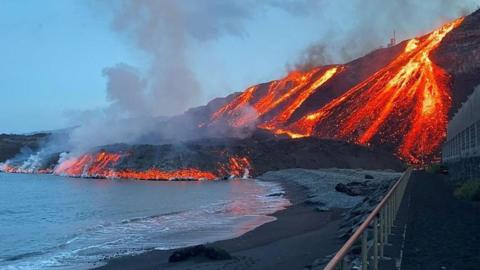 Lava flow on cliffside into ocean