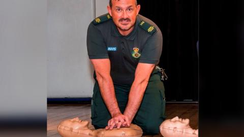 Jason Carlyon from YAS practicing CPR on a manikin 