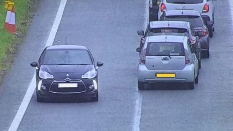 A car apparently driving the wrong way up a slip road