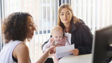 Woman and baby with a benefits officer