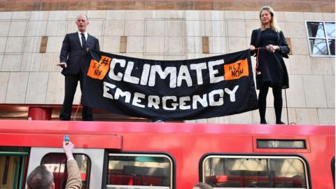 Climate protestors on top of bus