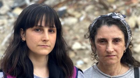 Gozde Burgac and her aunt Suheyla Kilic, pictured in front of rubble in Antakya