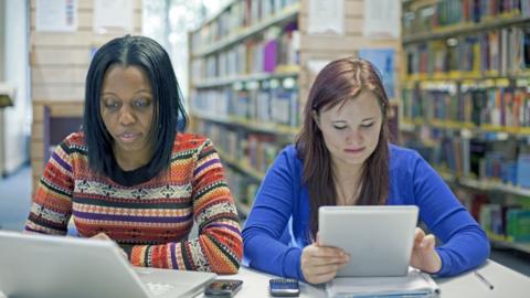 Stock image of students working in a library