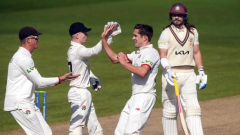 Lancashire celebrate the wicket of Rory Burns