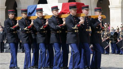 Republican guards carry the flag-draped coffin of French politician and Holocaust survivor Simone Veil during a tribute ceremony in the courtyard of the Invalides in Paris, France, on July 5, 2017