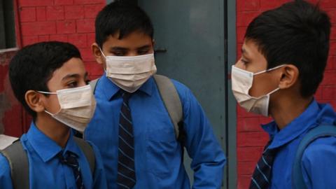 Students arrive at school in facemasks