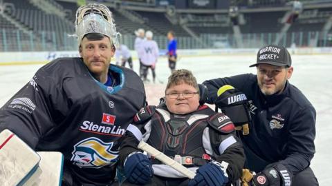 Ethan McClean with players in ice