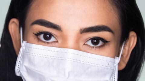 Woman's eyes and a mask