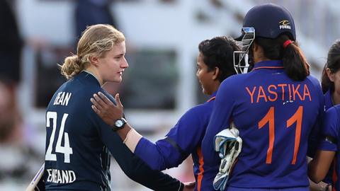 Charlie Dean and Deepti Sharma shake hands