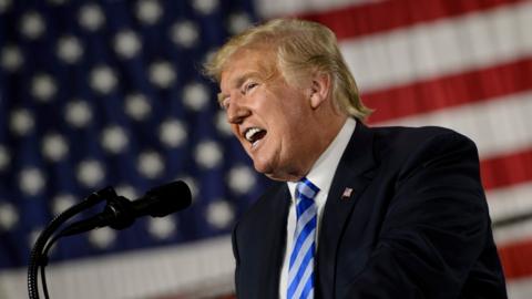 US President Donald Trump speaks during a signing ceremony for the John S. McCain National Defense Authorization Act for Fiscal Year 2019 at Fort Drum, New York, on August 13, 2018.