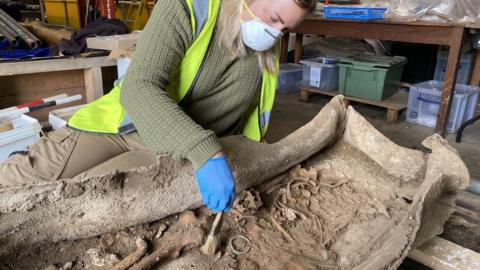 WYAS archaeologist Kylie Buxton working on the coffin