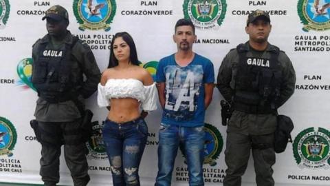 Photo released by Cali police of Paulin Karine Díaz and a man flanked by anti-kidnapping officers