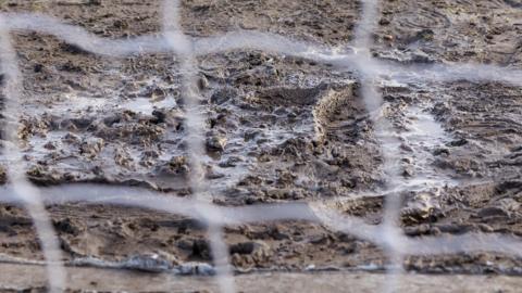 Muddy and waterlogged goalmouth area