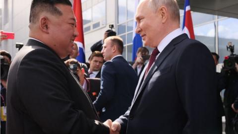 Russia's President Vladimir Putin (R) shakes hands with North Korea's leader Kim Jong Un (L) during their meeting at the Vostochny Cosmodrome in Amur region on September 13, 2023
