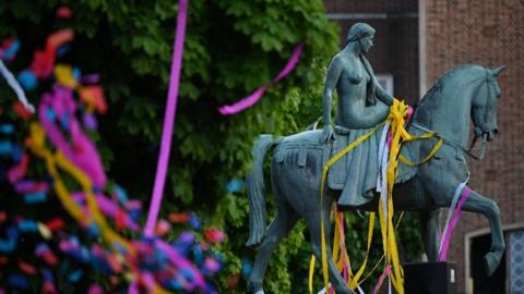 The statue of Lady Godiva is covered in confetti